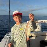 Kid with fish caught on Family friendly fishing charter